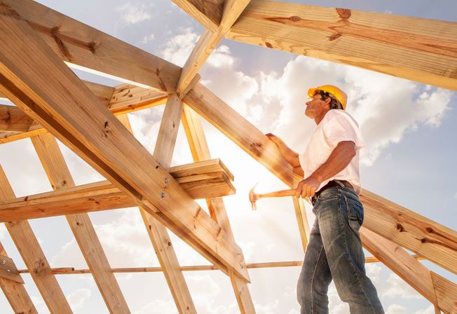 a roofer standing under an new roof