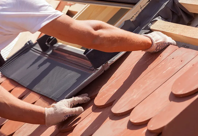 roof tiles being fitted on a roof